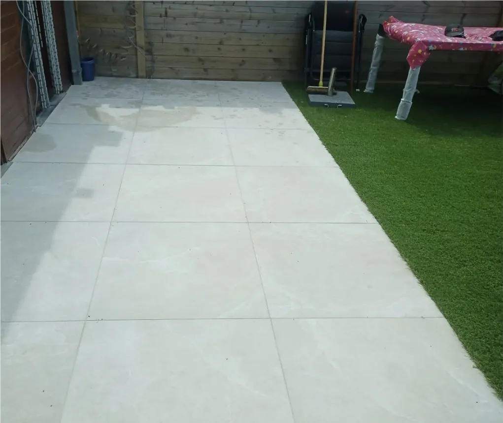 Terras met grote tegels naast het gras